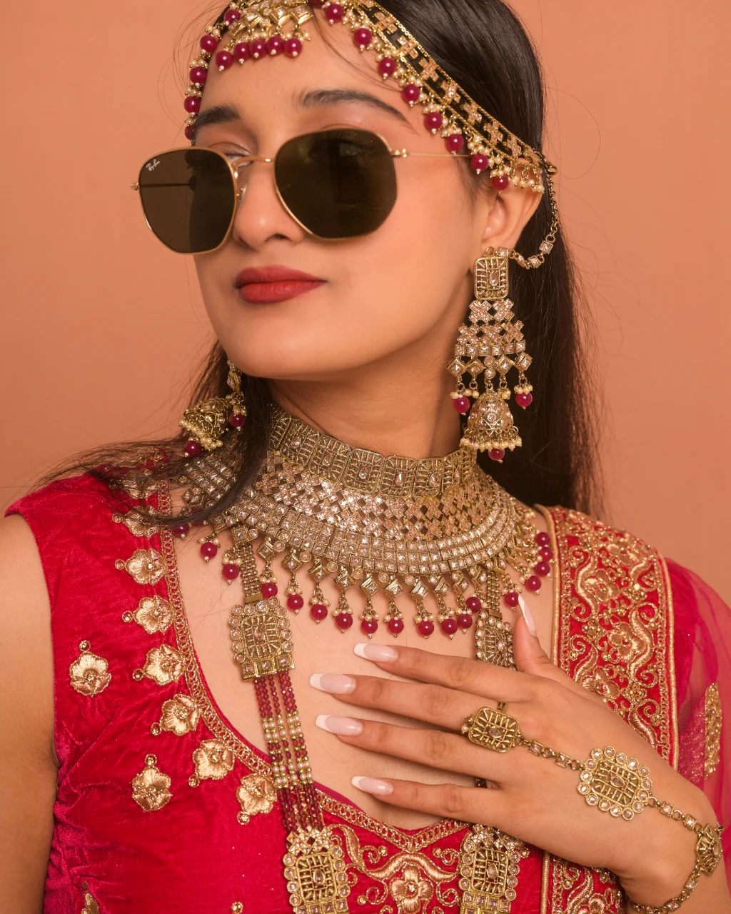 red bridal lehenga close up with gold embroidery traditional jewelry bridal look