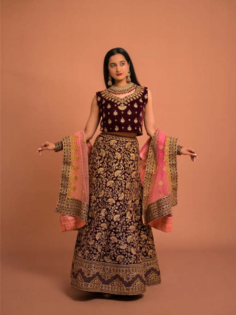 Royal Maroon Velvet Lehenga with Intricate Gold Zari Embroidery & Pink Net Dupatta